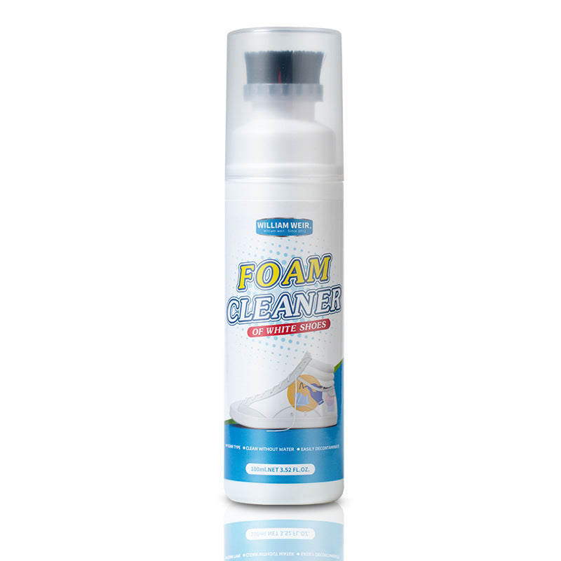 A white foam cleaner spray bottle with a clear cap and blue, yellow, and red text on the label, shown on a white background with a faint reflection below.
